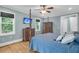 Comfortable main bedroom with hardwood floors, blue walls, a four-poster bed and modern furnishings at 4352 Park Island Rd, Hollywood, SC 29449