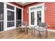 Cozy patio area with outdoor seating, perfect for enjoying a quiet moment, complete with red wood siding at 4352 Park Island Rd, Hollywood, SC 29449