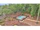 Aerial view of a private backyard pool surrounded by a lush green forest at 4352 Park Island Rd, Hollywood, SC 29449