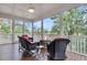 Relaxing screened porch featuring wicker chairs and a fire pit, perfect for enjoying the outdoors at 4352 Park Island Rd, Hollywood, SC 29449