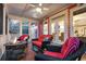 Cozy screened porch with comfortable seating and a stone fire pit at 4352 Park Island Rd, Hollywood, SC 29449