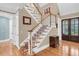 Inviting foyer with a staircase, hardwood floors, and elegant trim details near the entry door at 4352 Park Island Rd, Hollywood, SC 29449