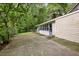 Spacious backyard featuring a concrete patio and ample green space surrounded by trees and foliage for privacy at 4822 Parker Dr, North Charleston, SC 29405