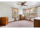 Bedroom featuring two windows, overhead fan, carpeted floors, and wooden furniture at 4822 Parker Dr, North Charleston, SC 29405