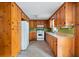 Galley kitchen featuring wooden cabinets, white appliances and neutral countertops, ready for a personal touch at 4822 Parker Dr, North Charleston, SC 29405