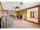 Cozy living room with brick fireplace, wood paneling, built-in shelving, and access to another room at 4822 Parker Dr, North Charleston, SC 29405