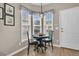 Cozy breakfast nook features a round table, three chairs, and natural light streaming in from large windows at 513 Sea Foam St, Summerville, SC 29486
