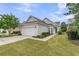 Charming single-story home with a two-car garage, well-manicured lawn, and colorful landscaping at 513 Sea Foam St, Summerville, SC 29486