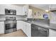 Modern kitchen features stainless steel appliances, white cabinets, granite countertops, and an eat-in bar at 513 Sea Foam St, Summerville, SC 29486