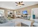 Bright and airy living room featuring modern furnishings, wood-look floors, and an open layout to the dining area at 513 Sea Foam St, Summerville, SC 29486