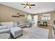 Spacious living room with modern decor, wood floors, a ceiling fan, and seamless flow into the dining area at 513 Sea Foam St, Summerville, SC 29486