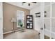 This home office features stylish decor, built-in shelving, natural light, and a modern ceiling fan at 513 Sea Foam St, Summerville, SC 29486
