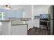 Well-equipped kitchen featuring stainless steel appliances, white cabinets, and a breakfast bar overlooking the living area at 60 Fenwick Hall Allee # 738, Johns Island, SC 29455