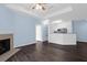 Relaxing living space with a fireplace, ceiling fan, and wood floors, leading to the kitchen and other rooms at 60 Fenwick Hall Allee # 738, Johns Island, SC 29455