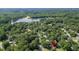 Aerial view of a home nestled in a wooded area near a lake at 617 Deepwood Ct, Moncks Corner, SC 29461