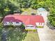 Aerial view of a well-maintained home with a red roof, detached garage, and spacious backyard at 617 Deepwood Ct, Moncks Corner, SC 29461