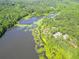 Picturesque aerial view of a tree-lined lake with lush greenery on its shores, creating a serene and natural landscape at 617 Deepwood Ct, Moncks Corner, SC 29461