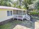 Backyard of home featuring a screened porch, white railings, and a small barbecue grill at 617 Deepwood Ct, Moncks Corner, SC 29461