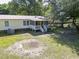 View of the backyard, featuring a screened porch, swing set, and spacious grassy area at 617 Deepwood Ct, Moncks Corner, SC 29461