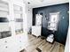 This bathroom features wood-look flooring, a charming vanity, and stylish black accent wall at 617 Deepwood Ct, Moncks Corner, SC 29461