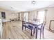 Open-concept dining room featuring a wooden table with bench seating and wood-look vinyl floors at 617 Deepwood Ct, Moncks Corner, SC 29461