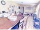 Bright dining area with a large wood table, vinyl floors, and abundant natural light at 617 Deepwood Ct, Moncks Corner, SC 29461