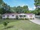 Charming single-story home with a well-manicured lawn, lush landscaping, and a welcoming front porch at 617 Deepwood Ct, Moncks Corner, SC 29461