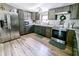 Modern kitchen featuring stainless steel appliances, gray cabinets, and stone countertops at 617 Deepwood Ct, Moncks Corner, SC 29461