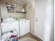 Functional laundry room with washer, dryer, and convenient shelving for storage at 617 Deepwood Ct, Moncks Corner, SC 29461