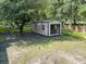 Backyard shed with an open door, surrounded by chain link fence and a wooded area at 617 Deepwood Ct, Moncks Corner, SC 29461