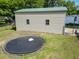 View of shed in the backyard, surrounded by a chain link fence and a trampoline at 617 Deepwood Ct, Moncks Corner, SC 29461