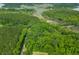 An aerial view shows the property's proximity to marshland and wooded areas near winding waterways at 6464 Saint Anthony Dr, Meggett, SC 29449