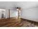 Open basement area featuring wood-look floors, white walls, and rustic support beams at 6464 Saint Anthony Dr, Meggett, SC 29449