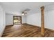 Unfinished basement space with wood-look flooring, support beam, and sliding glass door at 6464 Saint Anthony Dr, Meggett, SC 29449