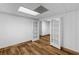 Partially finished basement with white-painted walls, wood-look flooring, and paneled doors at 6464 Saint Anthony Dr, Meggett, SC 29449