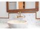 Close-up of a bathroom featuring a designer stone sink, wood mirror, and stylish fixtures at 6464 Saint Anthony Dr, Meggett, SC 29449