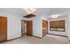 Bright bedroom with neutral carpet, wood trim window, double closet, and access to the hallway at 6464 Saint Anthony Dr, Meggett, SC 29449