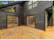 Large deck area with wood plank floor, sliding glass doors and view of the mature trees at 6464 Saint Anthony Dr, Meggett, SC 29449