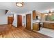 Open kitchen design with hardwood floors, wood cabinets, stainless steel appliances, and tiled backsplash at 6464 Saint Anthony Dr, Meggett, SC 29449