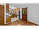 Bright kitchen with wooden cabinets, stainless steel refrigerator, and an adjacent door to the outside at 6464 Saint Anthony Dr, Meggett, SC 29449