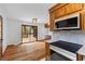 Bright kitchen space with hardwood flooring, stainless appliances, and sliding glass doors leading to deck at 6464 Saint Anthony Dr, Meggett, SC 29449