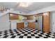 Well-lit kitchenette has light wood cabinets, white appliances, and unique flooring at 6464 Saint Anthony Dr, Meggett, SC 29449