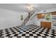 Charming kitchenette features black and white tile flooring and stairs to upper level at 6464 Saint Anthony Dr, Meggett, SC 29449