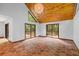 Spacious living room with a view of the wooded landscape and access to the back deck area at 6464 Saint Anthony Dr, Meggett, SC 29449