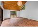 Spacious living room with a wood paneled vaulted ceiling, terra-cotta tile flooring and sliding glass doors to the outside at 6464 Saint Anthony Dr, Meggett, SC 29449