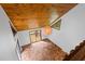 Bright living area showcasing vaulted wood ceilings, a triangular window, and rustic terra cotta tile flooring at 6464 Saint Anthony Dr, Meggett, SC 29449