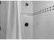 Shower is fully tiled, with decorative band and a sleek showerhead at 6464 Saint Anthony Dr, Meggett, SC 29449