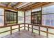 Rustic sunroom with a wood floor, wooden frame windows with a natural wooded view and bright natural lighting at 6464 Saint Anthony Dr, Meggett, SC 29449