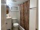 Cozy bathroom with a sink, toilet, and bathtub with a colorful shower curtain at 65 Vanderhorst St # C, Charleston, SC 29403