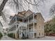 Rear exterior of a multi-story home with multiple balconies, offering outdoor living spaces at 65 Vanderhorst St # C, Charleston, SC 29403